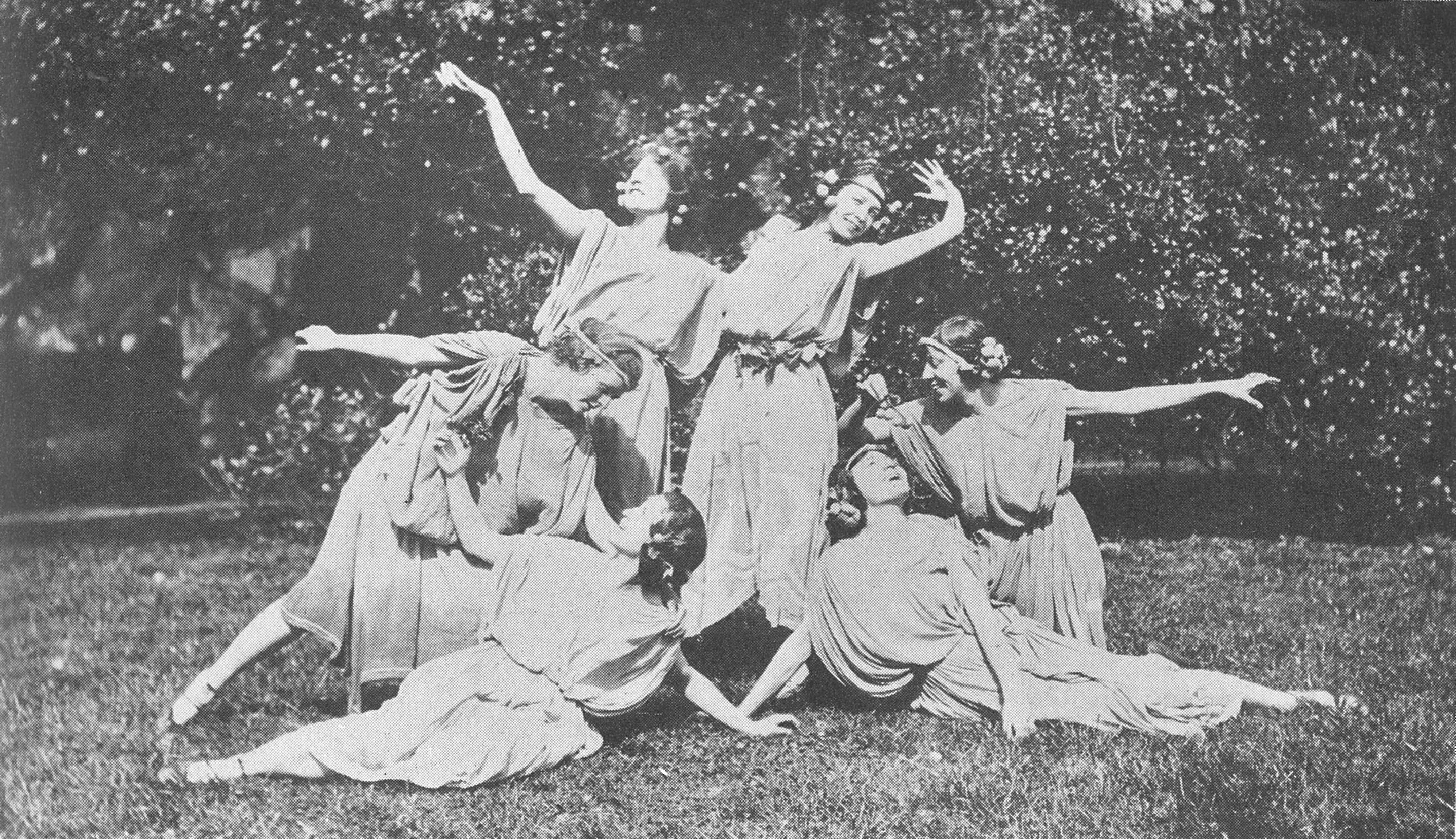 Black and white photo of women in white forming a dramatic tableau.