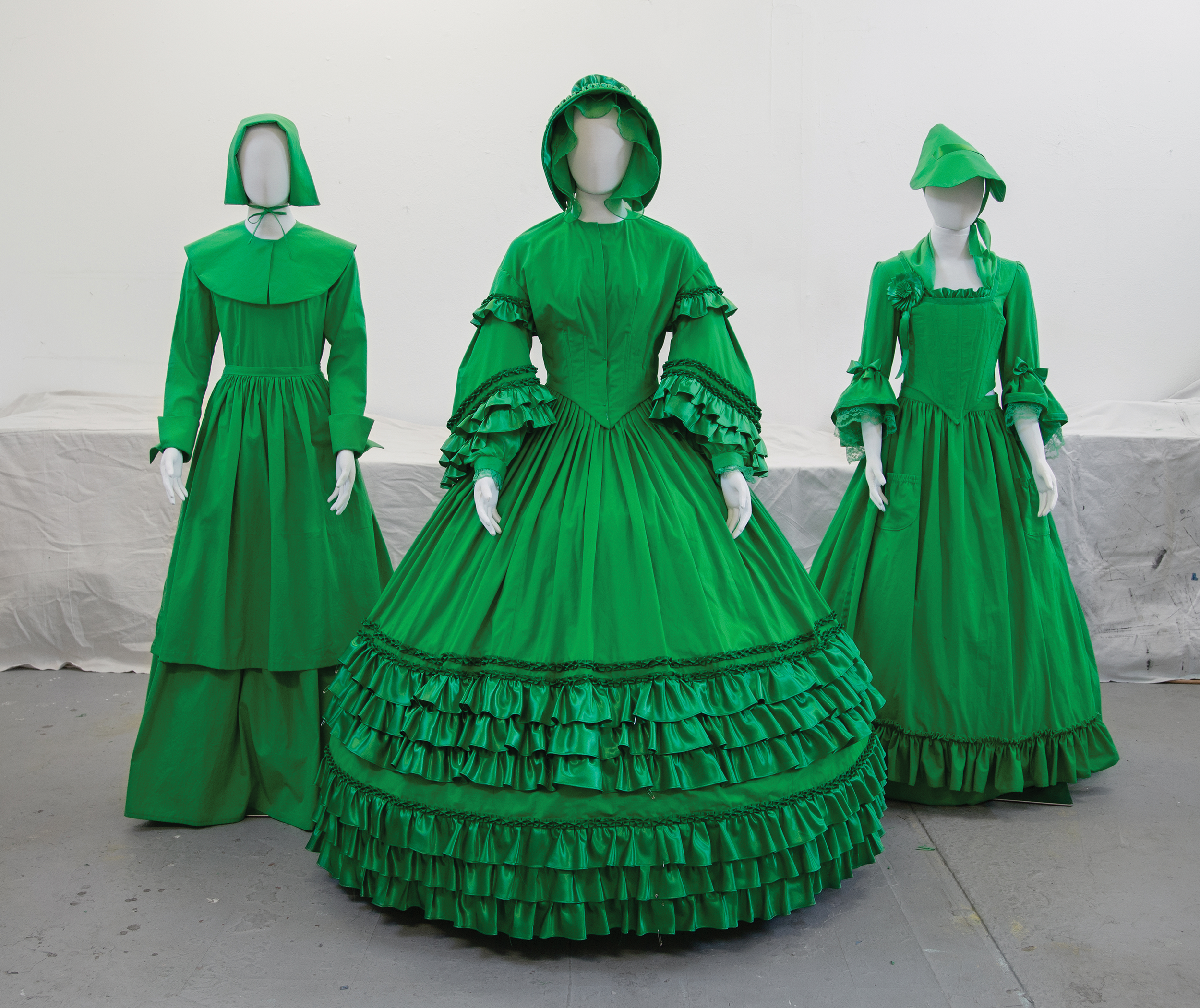 Photo of three chroma key green dresses representing the Pilgrim, American Revolution, and Civil War eras.