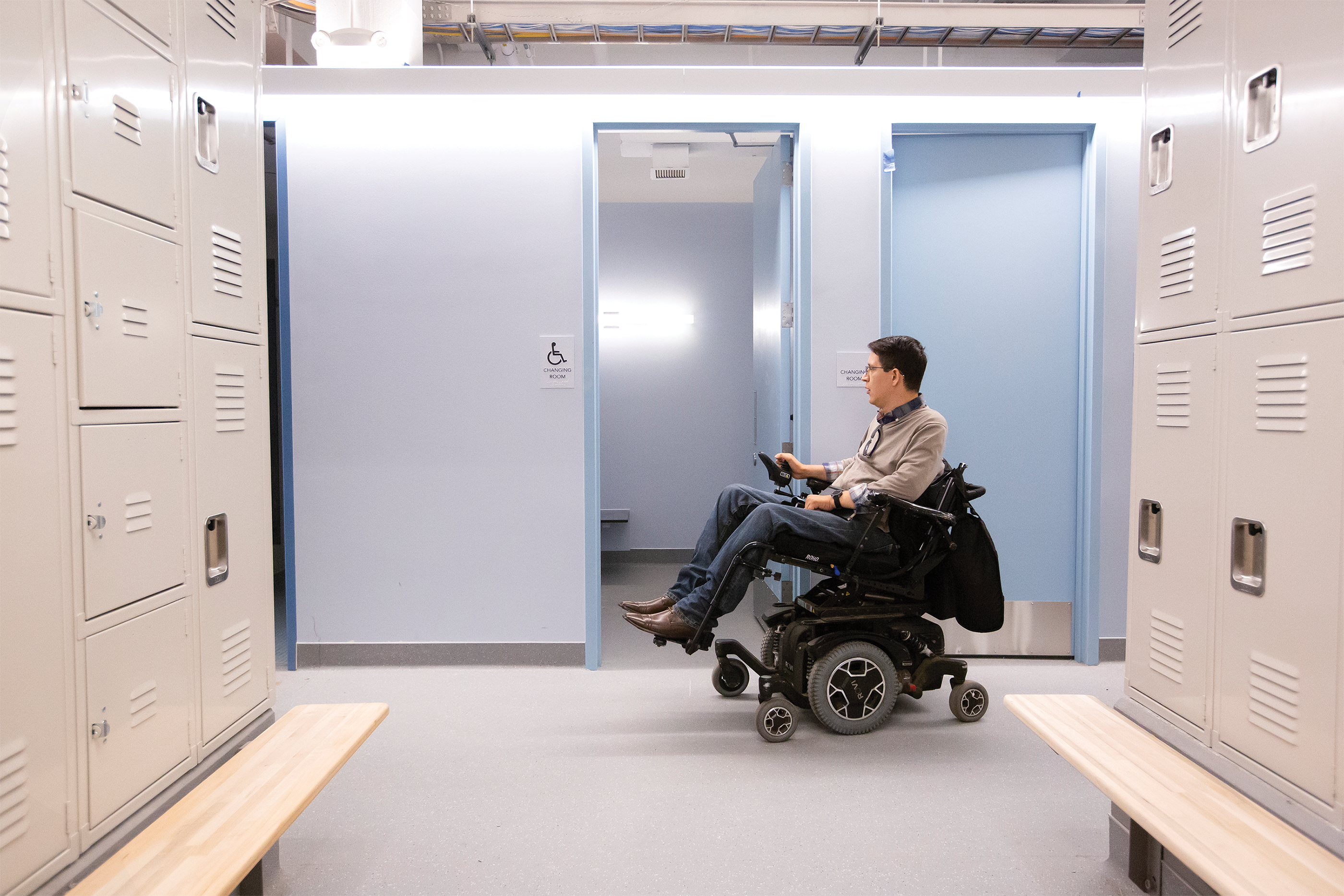 Photo of Ben Perez ’13, who uses a wheelchair, in the new locker room, which is more accessible and more private.