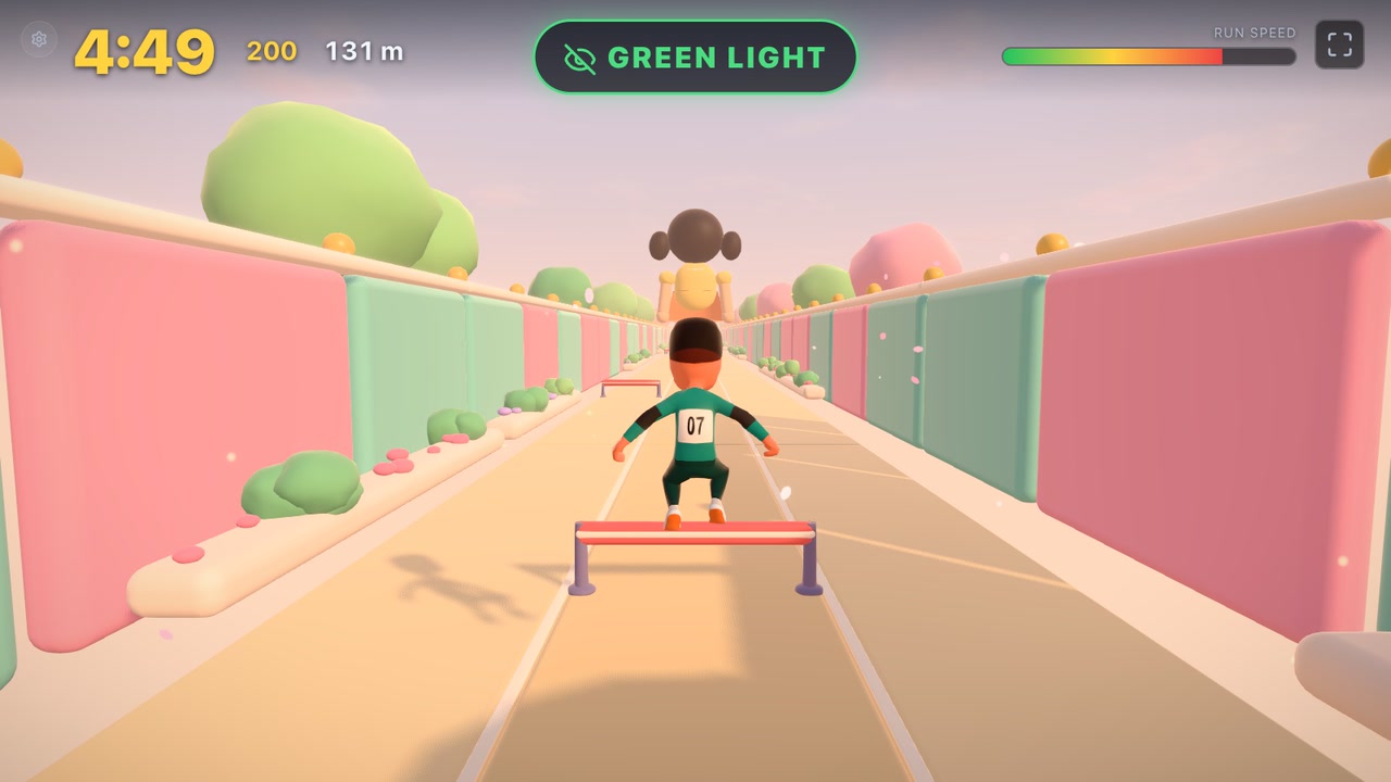 Leaping a red-and-white hurdle on green light, the giant doll at the end of the track