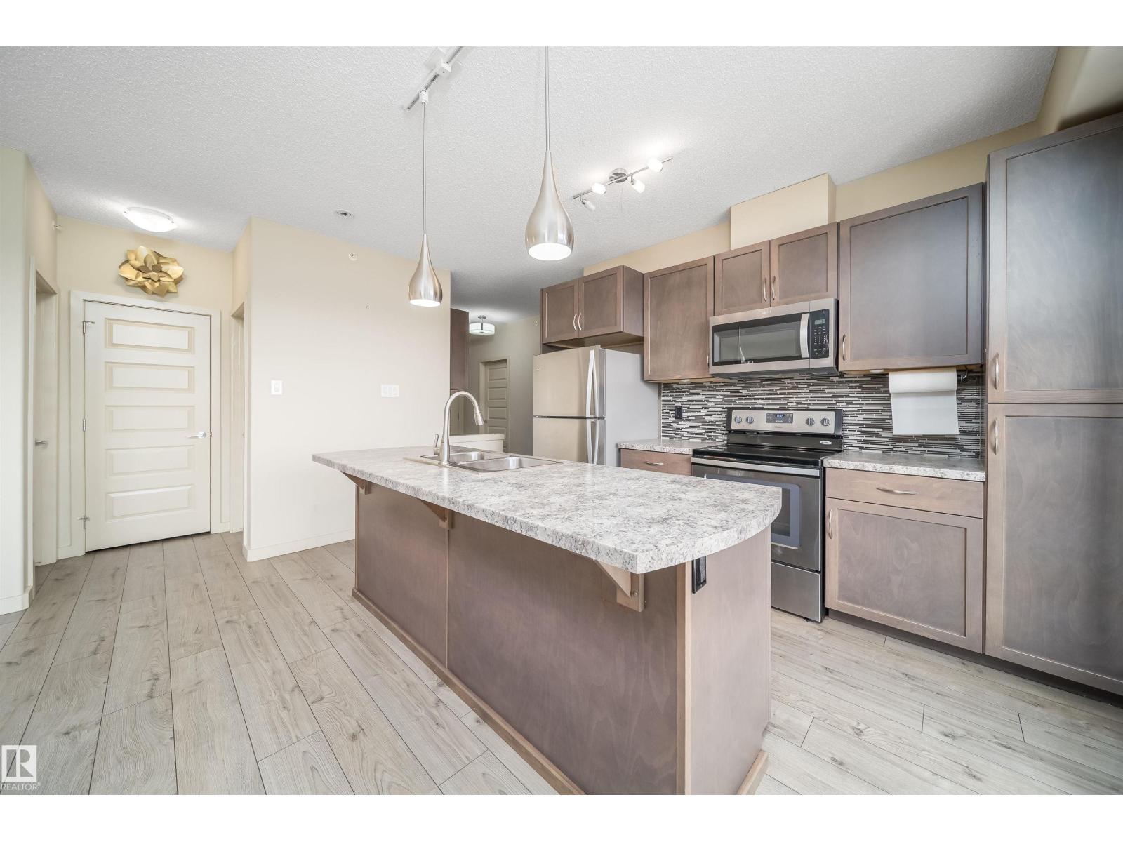 #421 4008 SAVARYN DR SW Edmonton Alberta Canada Sale residential Aziz Dhamani INITIA Real Estate