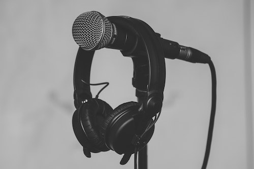 Black Headset Hanging on Black and Gray Microphone home studio article featured image