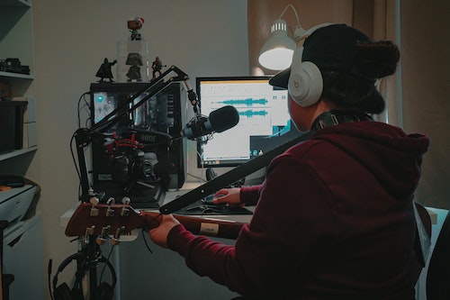 unrecognizable guitarist recording music at home studio recording studio desks article