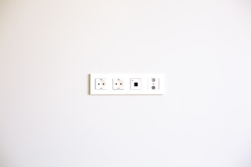 white electrical socket in white wall
