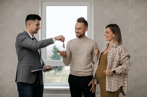 couple speaking with realtor