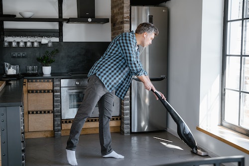 person cleaning kitchen floor