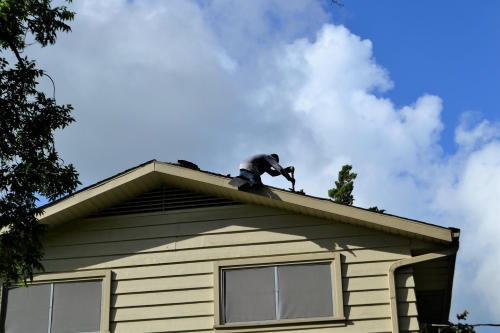 natural disaster relief person repairing residential roof