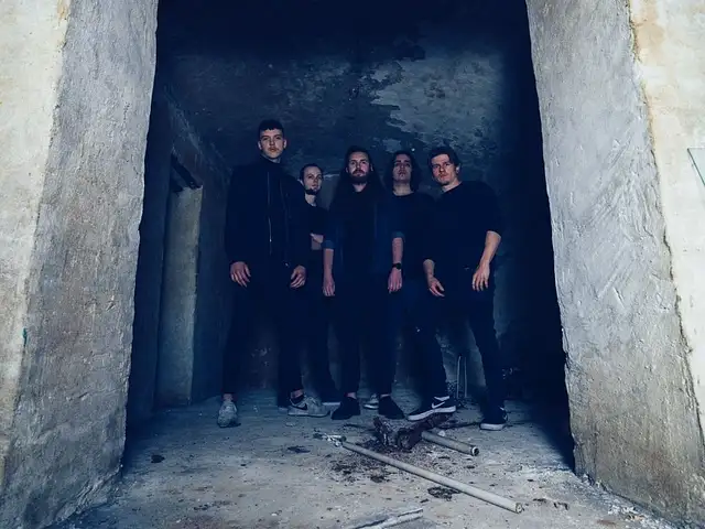 Monosphere (Picture of the band standing behind the entry of a concrete ruin)