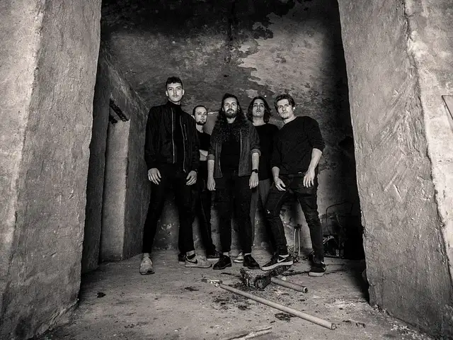 Monosphere (Sepia photo of the band standing behind the entry of a concrete ruin)