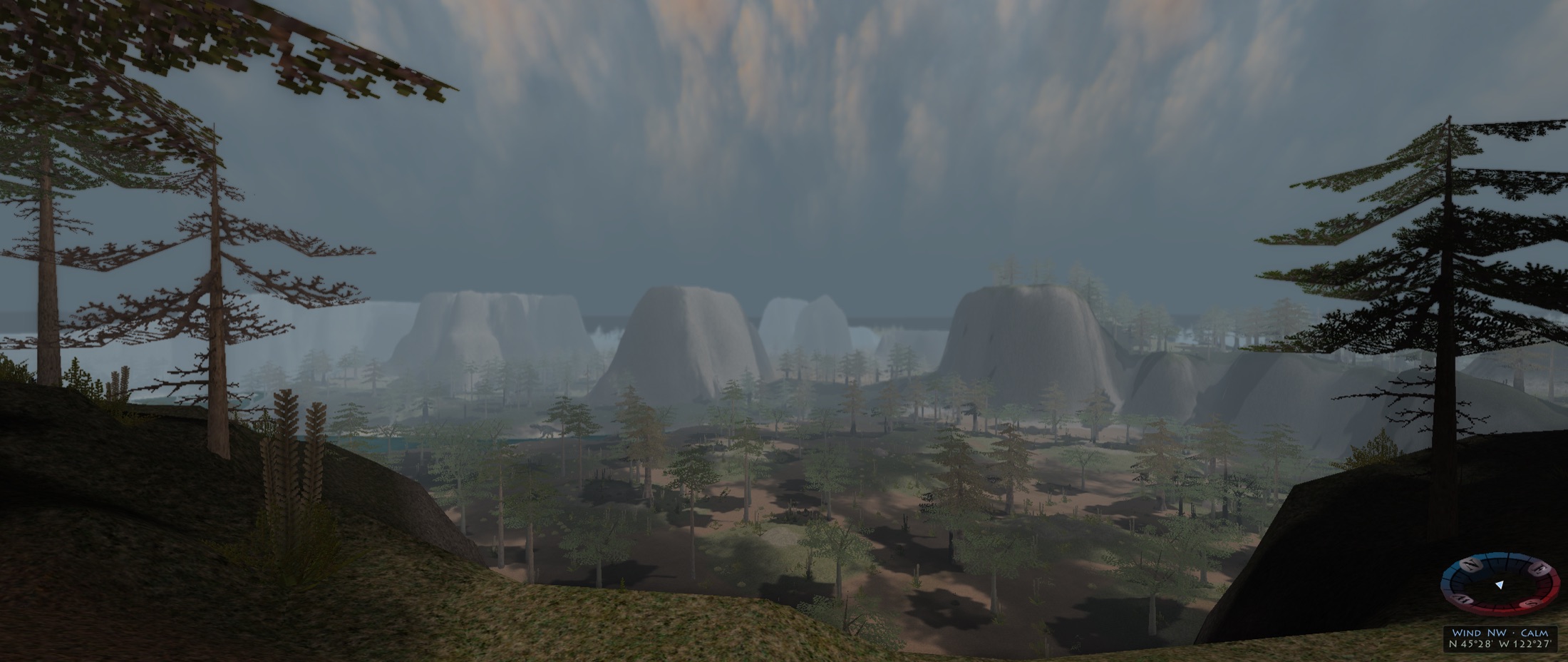 A misty valley of cliffs and conifers seen from a ridge