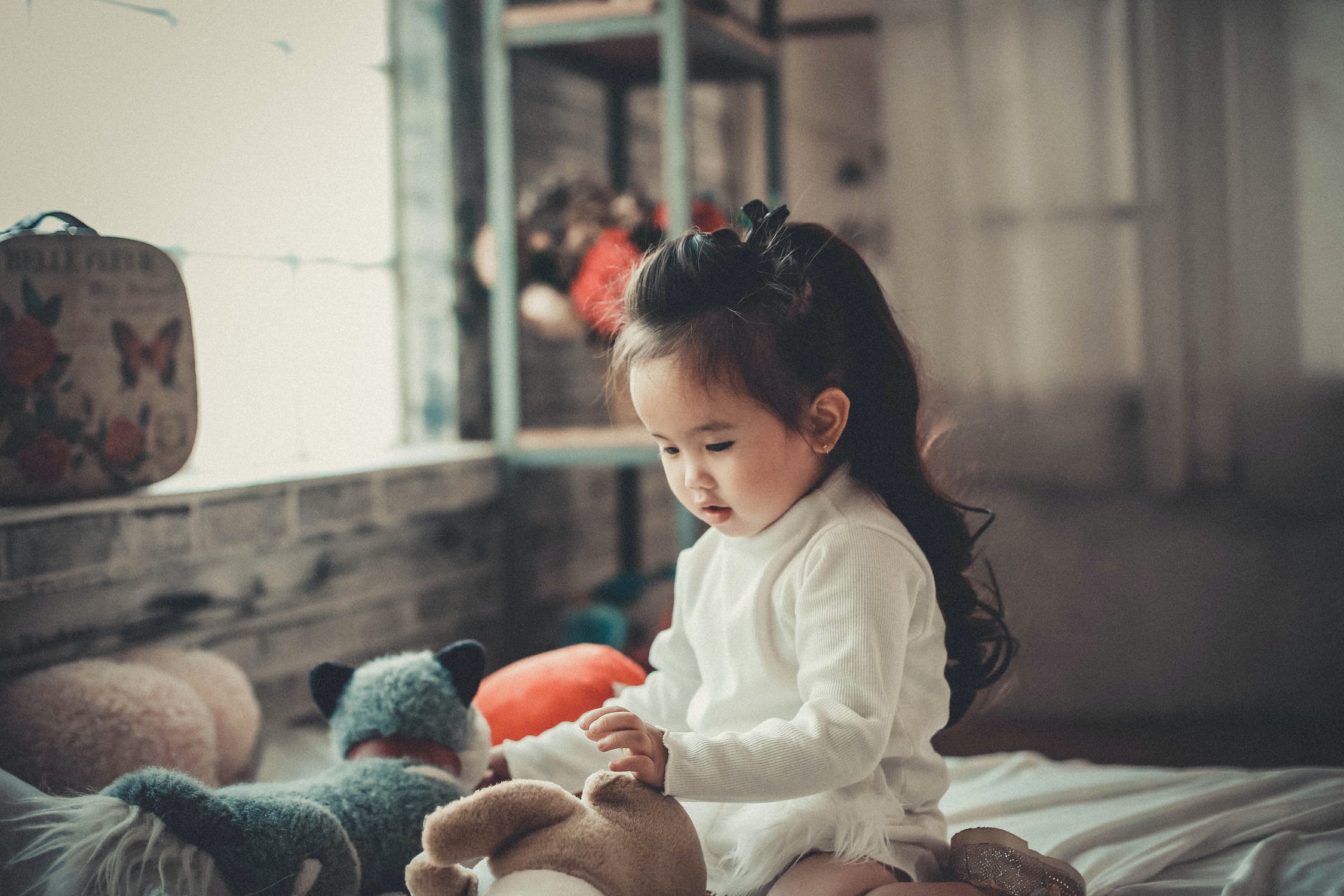 Girl at home with stuffed toys