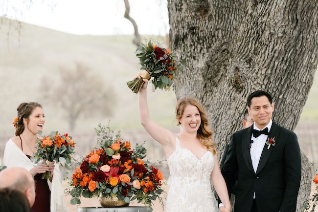 Bride and groom getting married on the Cass Winery vineyard in Paso Robles in winter under the oak tree