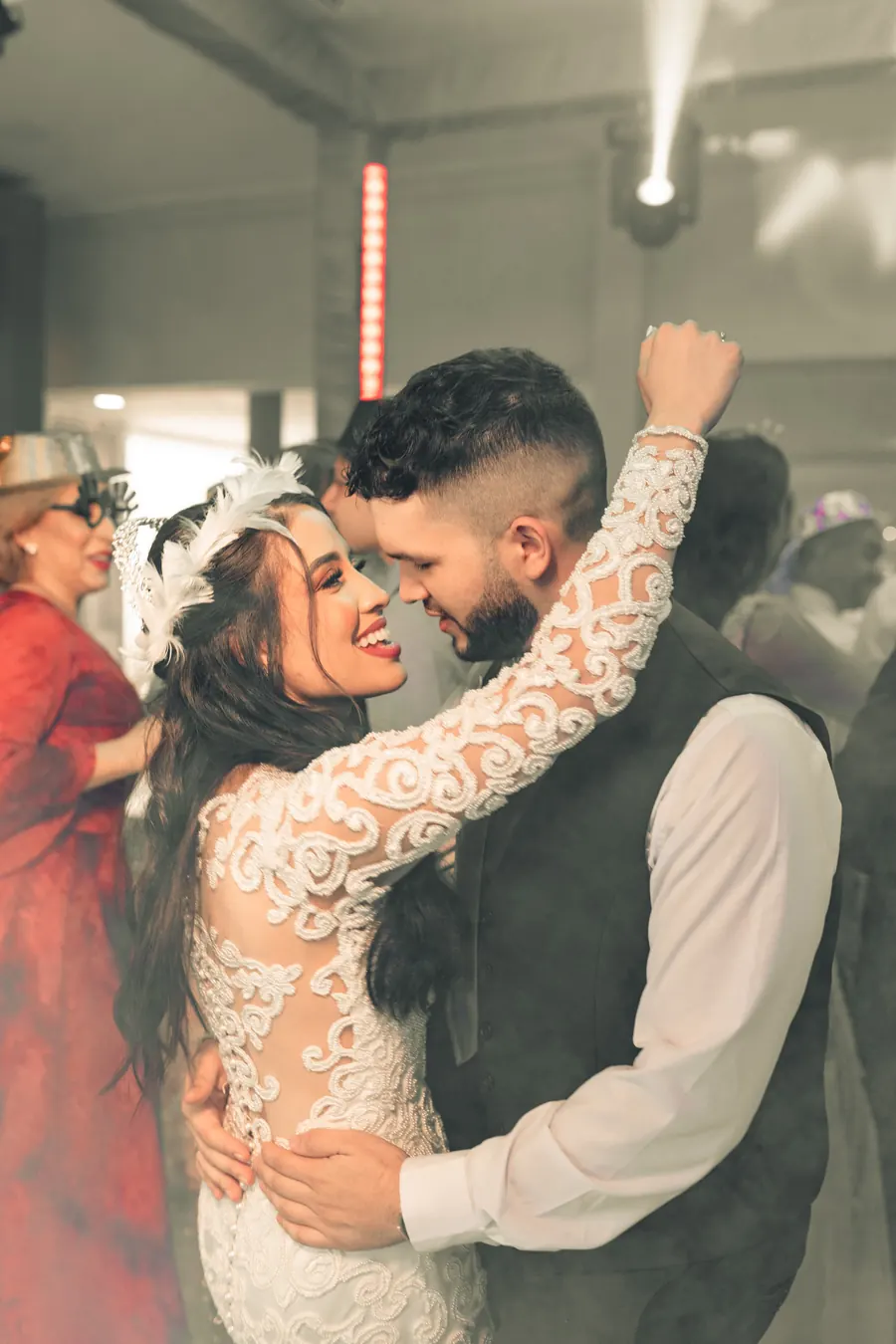 Newlyweds dancing closely at their reception