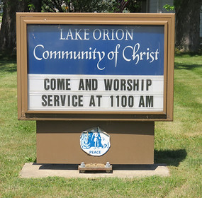 Sign for Lake Orion Community of Christ reading 'Come and Worship Service at 11:00 AM'