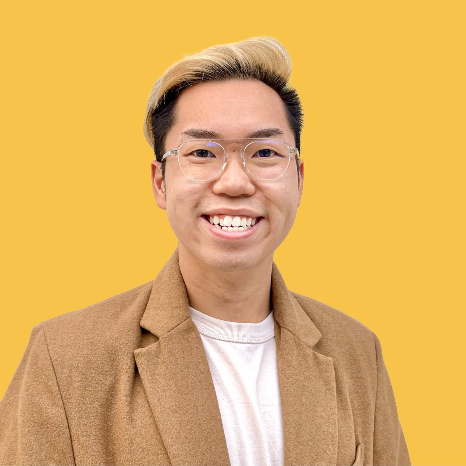 A headshot of the student smiling and in front of a bright yellow backdrop.