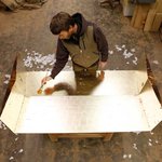 Bay Area furniture designer and CCA alumnus Florian Roeper puts the finishing touches on a gold-leafed surface in his Alameda atelier.