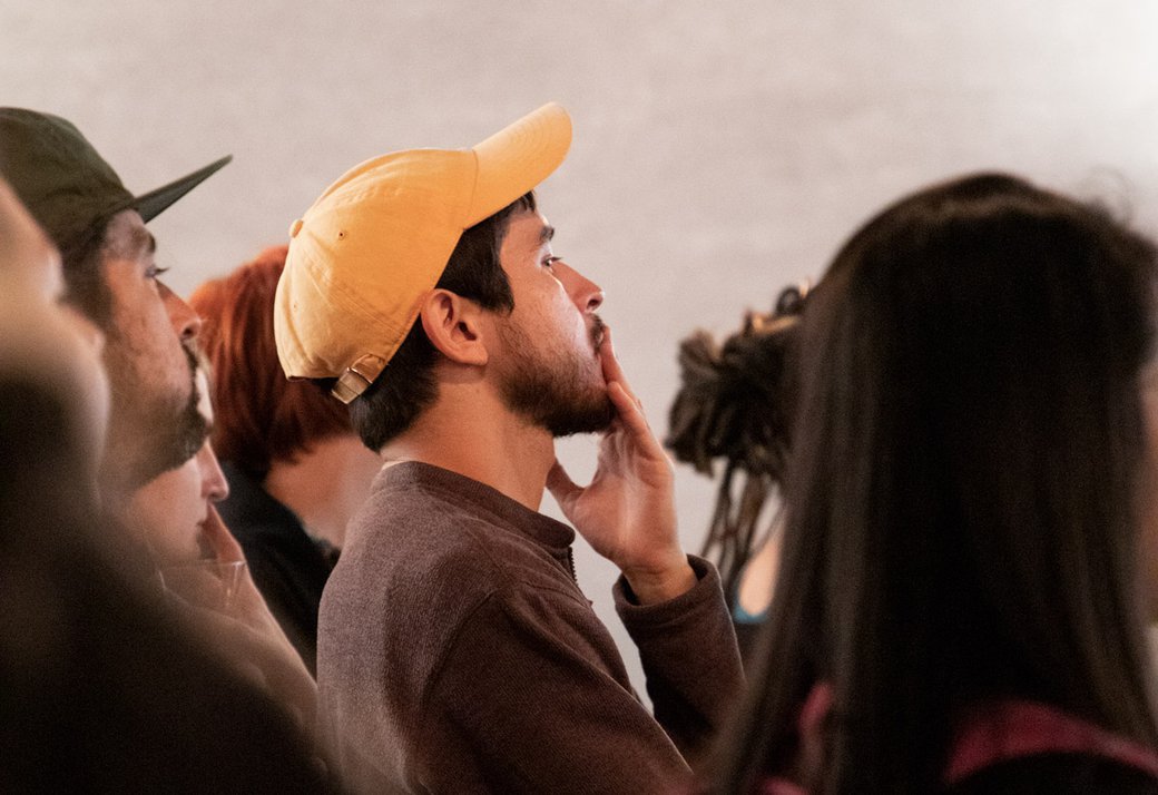 A student looks into the distance at an art practical event.