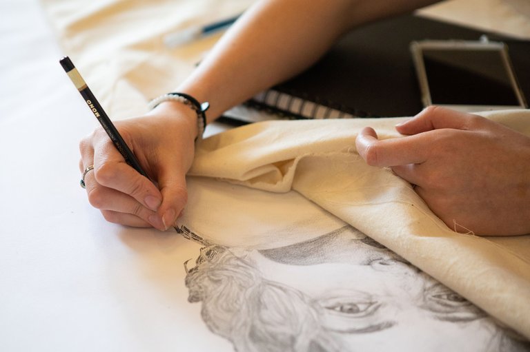 Natalia Poehner drawing a self-portrait in her studio