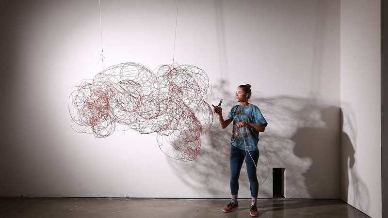 A CCA Furniture student installing her work in a gallery.