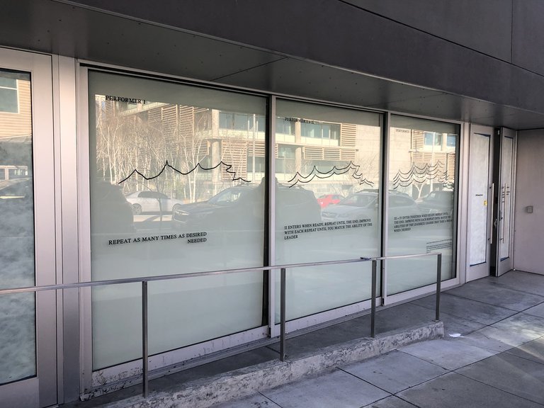 Raven Chacon's Whistle Quartet (for dog whistles), 2001, in the windows of the Wattis Institute during spring 2021.