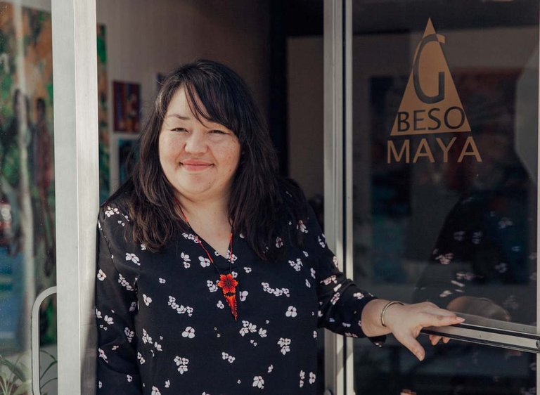 Alumna Yadira Cazares stading outside of her art gallery, Galería Beso Maya.