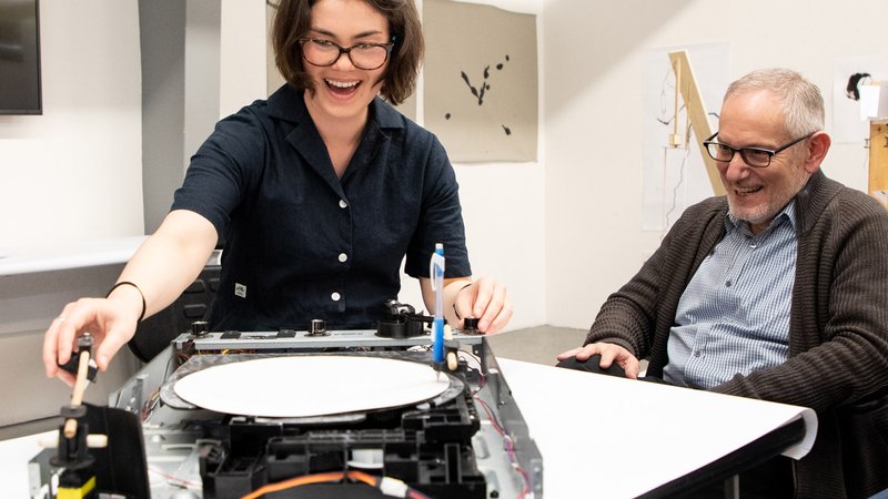 Photograph of MFA in Design student Sarah Bonnickson as she demonstrates her drawing machine.