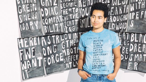 Lukaza Branfman-Verissimo in front of work