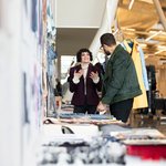 Fashion design student presenting fashion critique in Nave