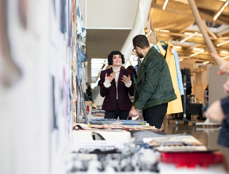 Fashion design student presenting fashion critique in Nave