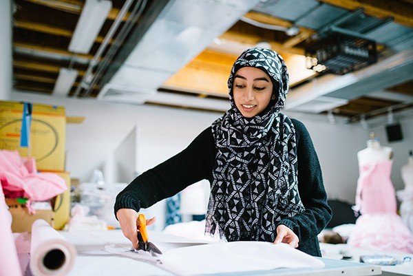 High school fashion student cutting patterns at CCA's pre-college program