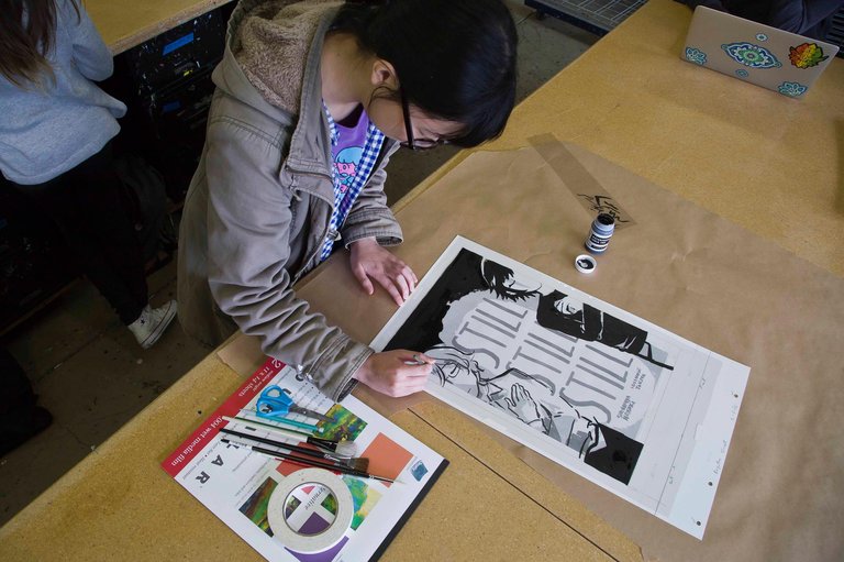 Illustration student painting a graphic poster