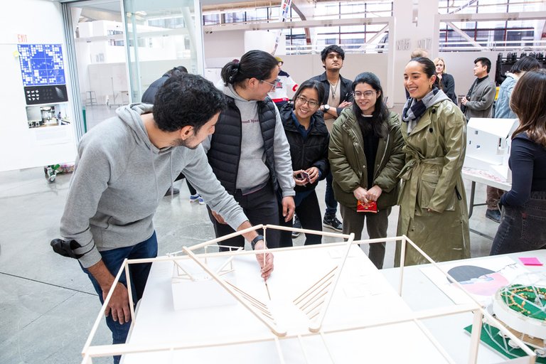 Students showing off their work at an Architecture Division mixer.