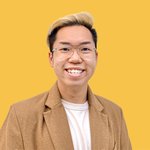 A headshot of the student smiling and in front of a bright yellow backdrop.