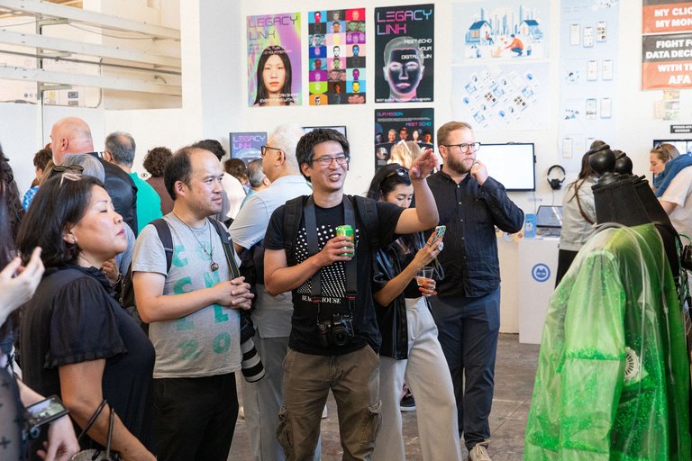 A student explains their work to a small group during the End-of-Year Architecture and Design exhibition.