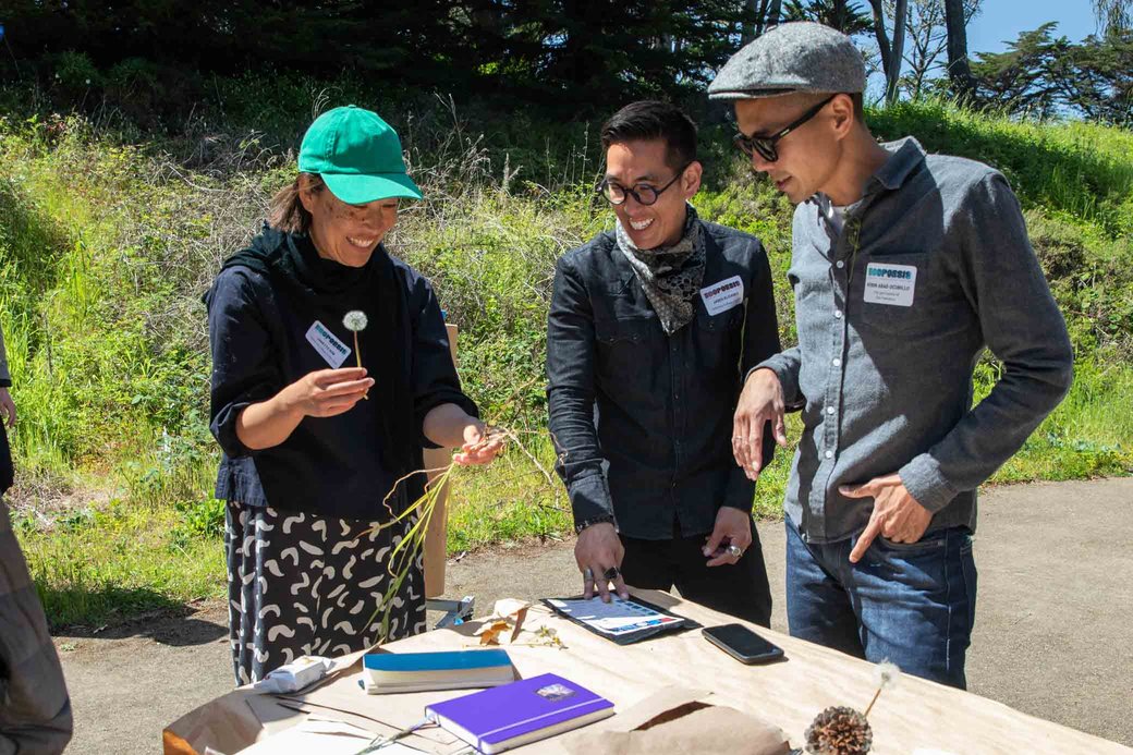 Participants laughing at an outdoor art event.