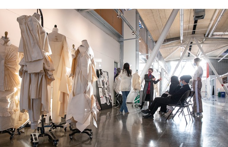 A fashion critique in a brightly lit room.