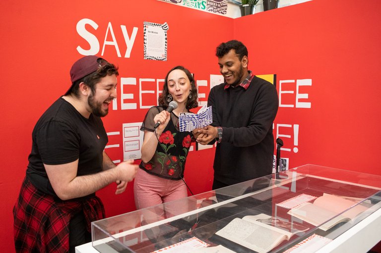 students read poetry from their experimental zine in the graphic design studio