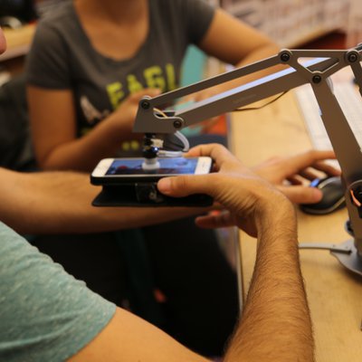 Students in the Hybrid Lab using the Robot Arm.