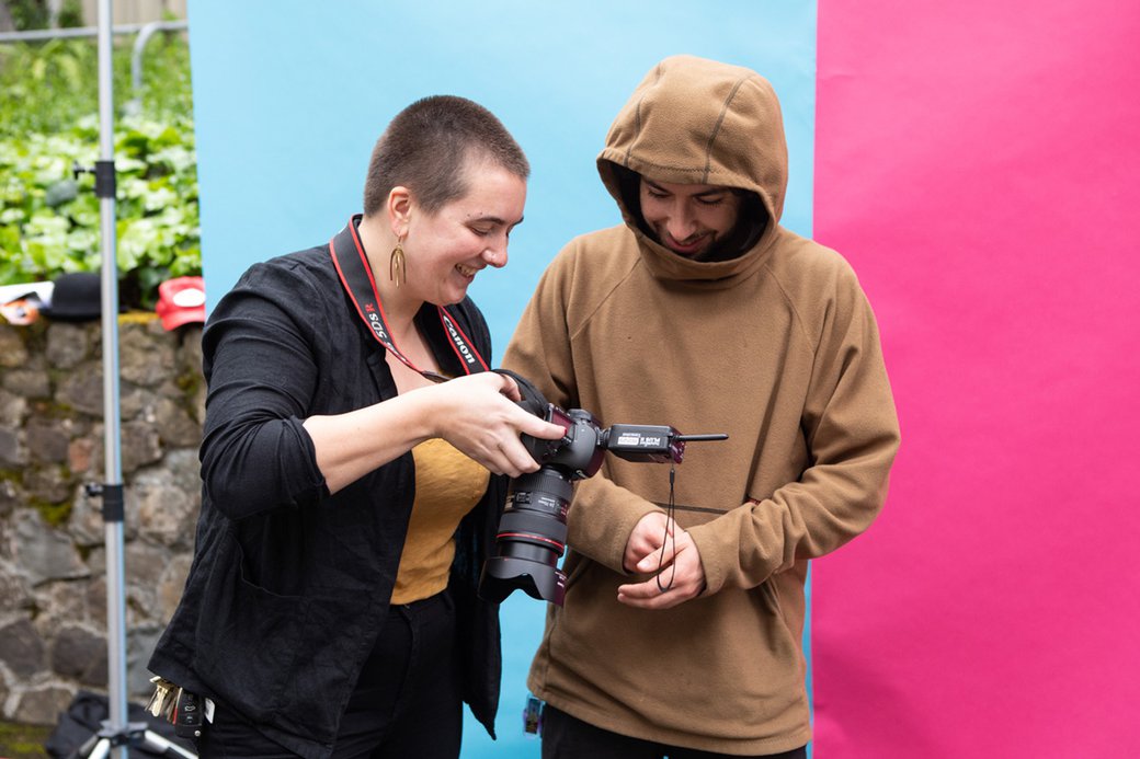Two people viewing an image on a digital camera.