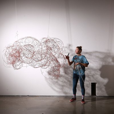 A CCA Furniture student installing her work in a gallery.