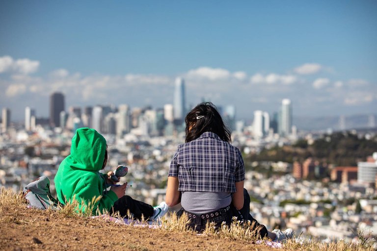 Two students take in the view from Bernal Hill.