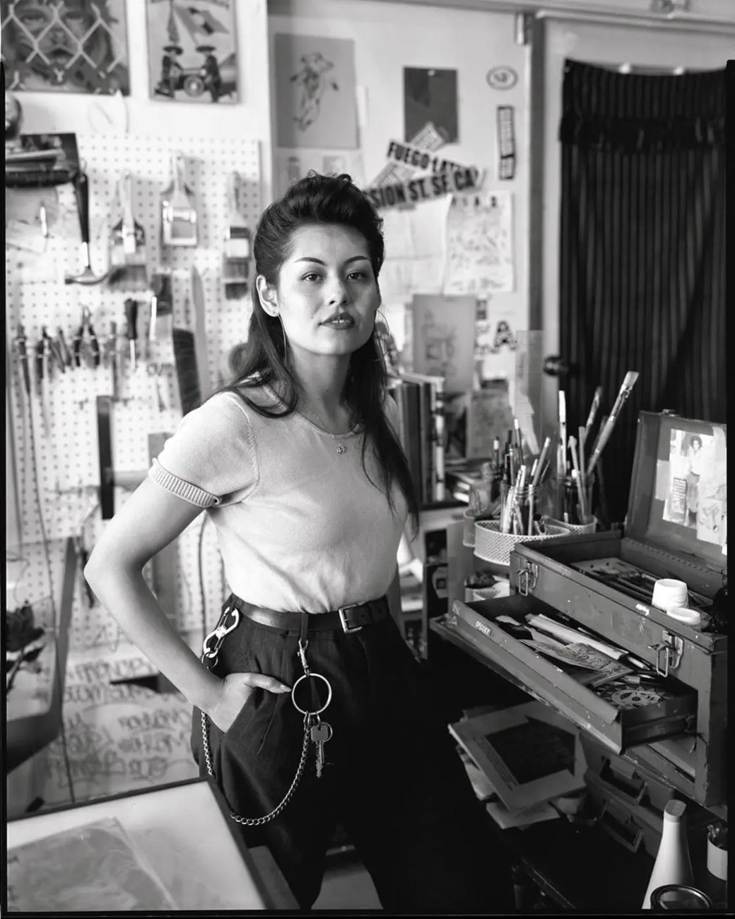 A black-and-white photo of Lauren D'Amato posing in a workshop