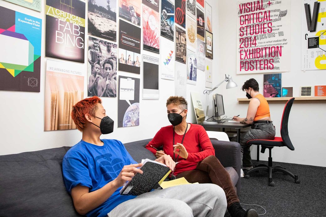 Faculty working with students in a colorful classroom