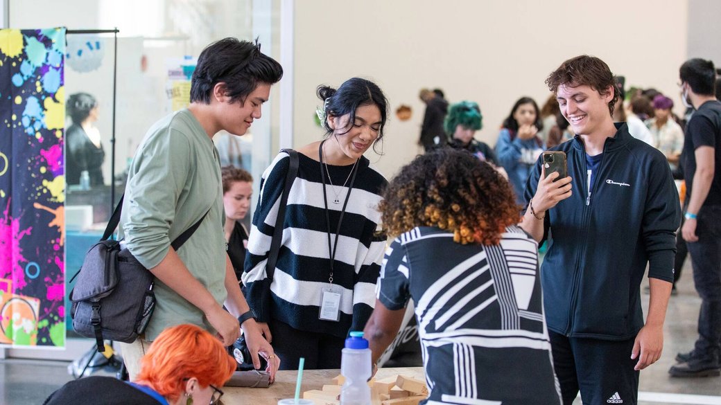 Students play Jenga around a table at CCA's Welcome Week