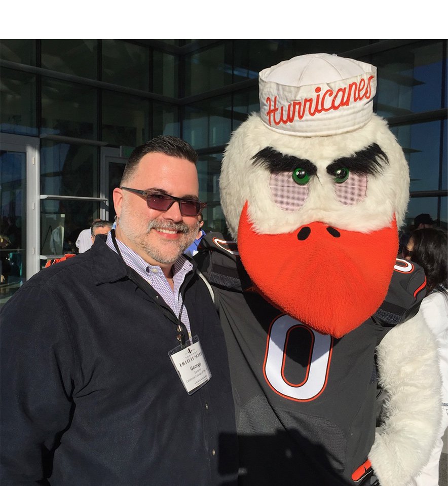 A photo of George Luis Sedano with a mascot.