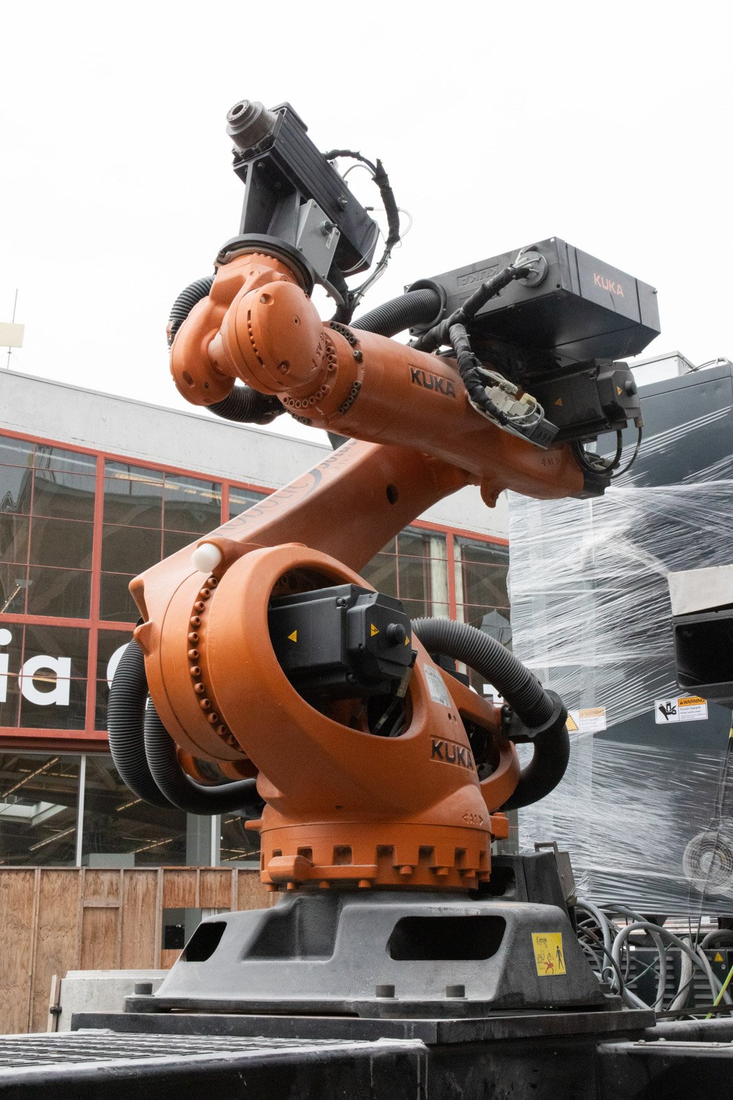 Photo of a large orange arm-shaped KUKA robot