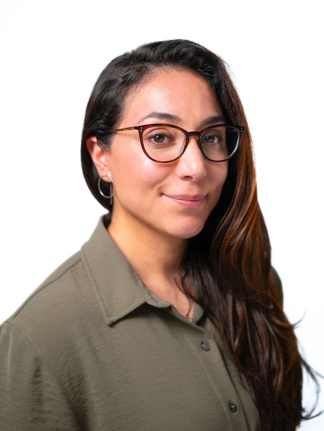 A headshot of artist and designer Melissa Ortiz amid a white backdrop.