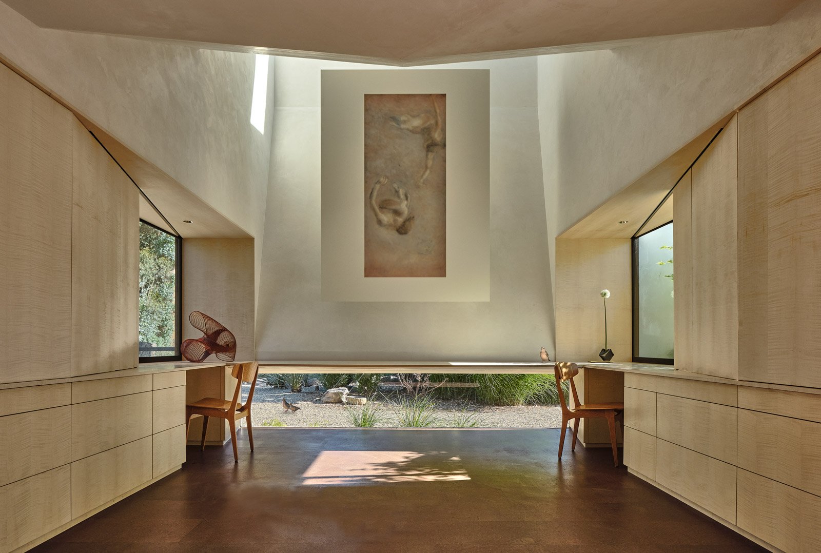 Photo of a cavernous bright contemporary room illuminated from a skylight.