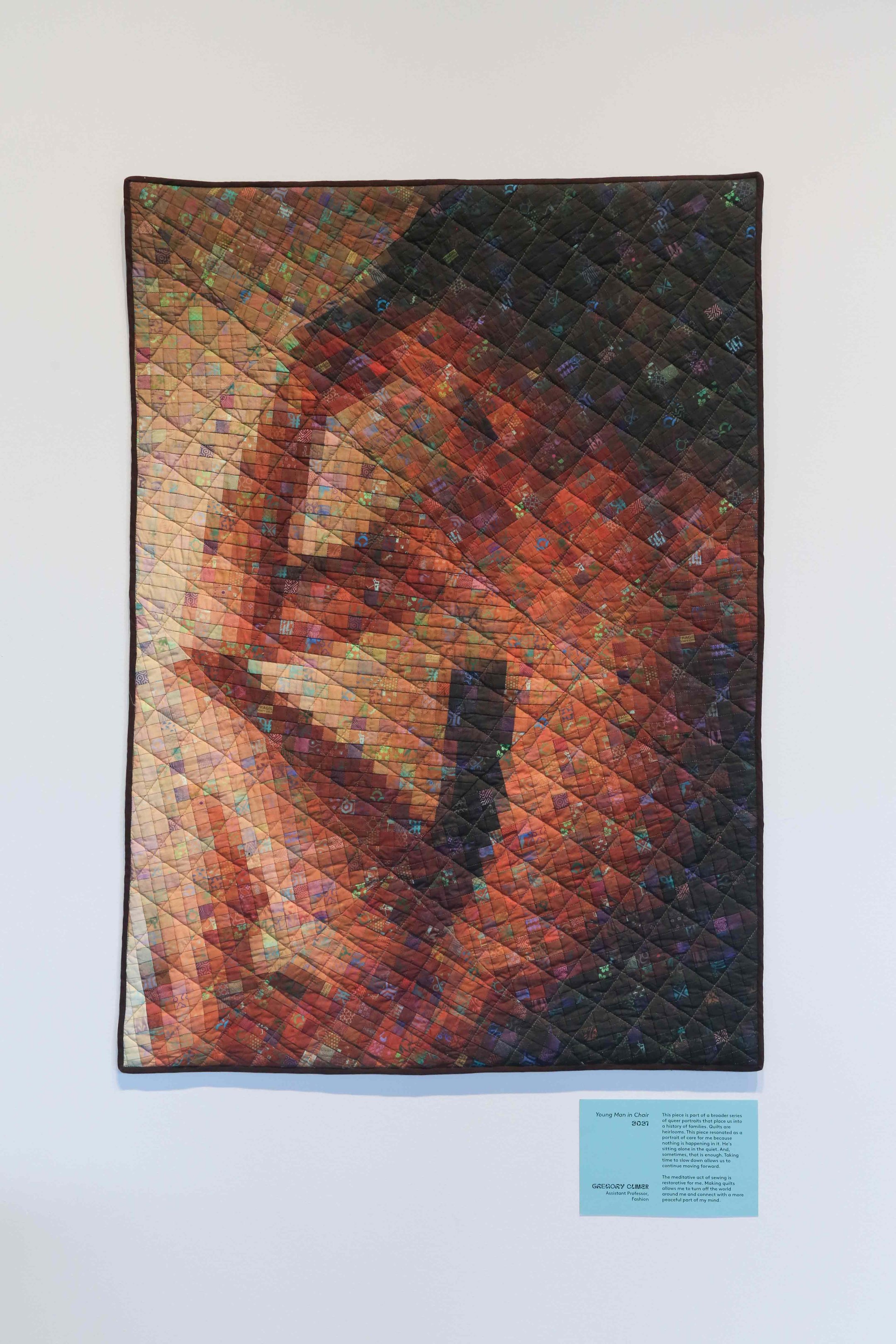 A close-up photo of an orange quilt with multiple geometric patterns intersecting.