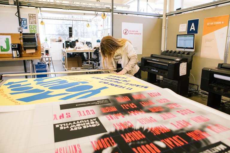 Student printing their graphic design large scale posters in the blotter studio